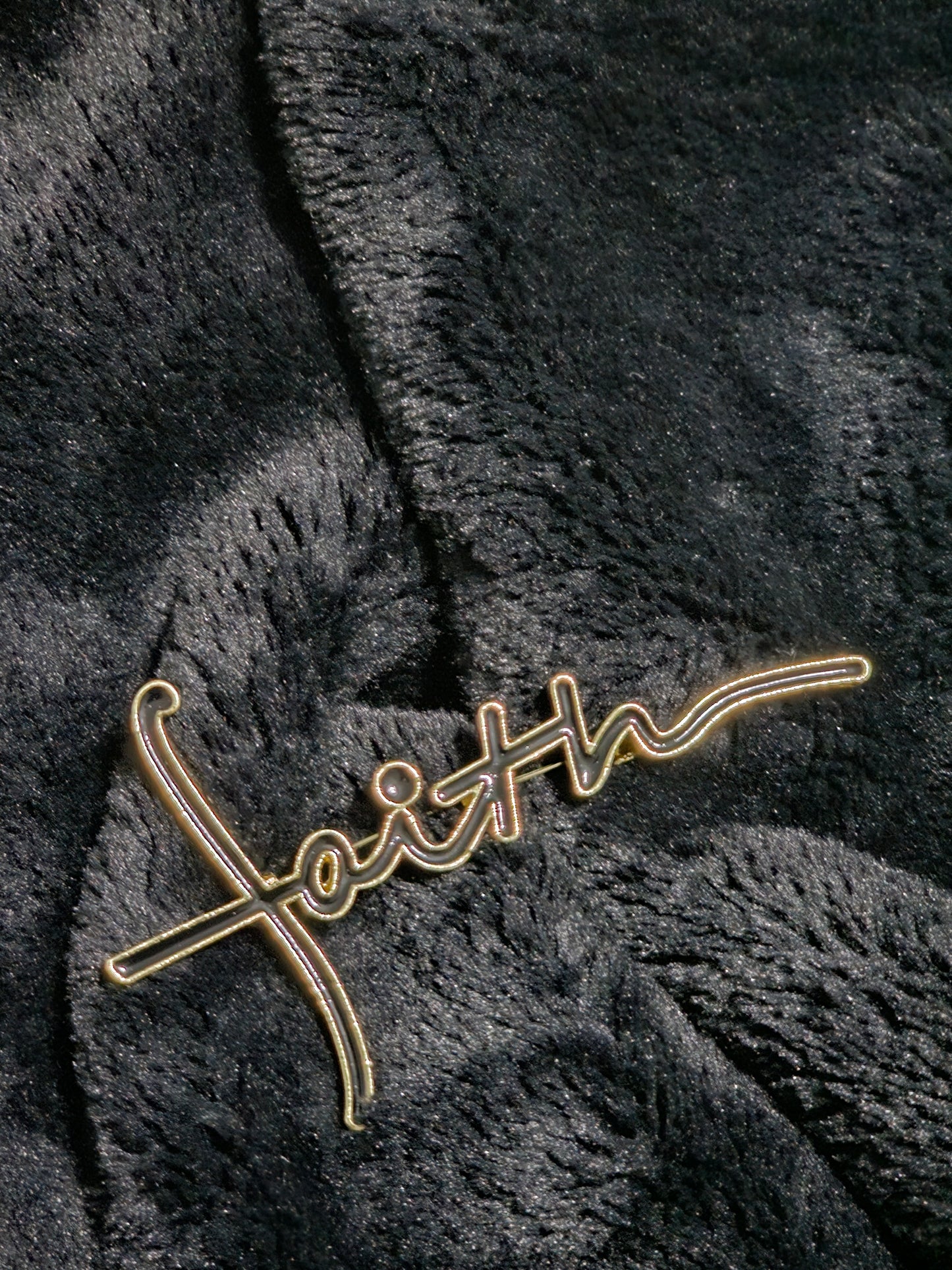 Strong gold metal mixed with black to grave word faith
