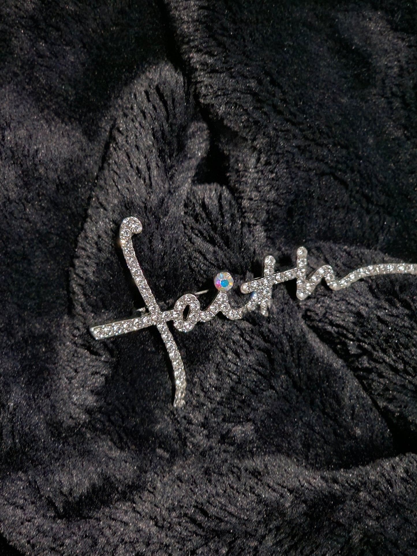 Diamanté encrusted letters spelling the word faith 